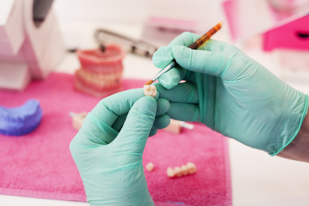 Dental technician working on a tooth crown